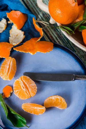 Top table view on peeling organic clementinesの写真素材