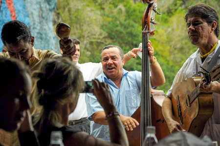 VINALES VALLEY, CUBA - JANUARY 19, 2013. Local Cuban band play Salsa and Cuban Son while tourist eating in restaurant in Vinales Valley, Pinar Del Rio province in Cuba, famous for tobacco plantations, caves and Valley itself.のeditorial素材