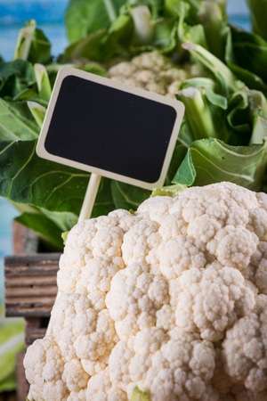 Fresh organic cauliflower head with copy space price tagの写真素材