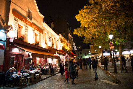 PARIS, FRANCE -  NOVEMBER 10, 2014 Cafe and Restaurant in Montmartre famous artist painting spot at night in Paris, Franceのeditorial素材