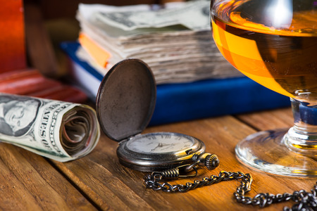 Wealthy man desk, cuban cigars dollar notes, vintage watch and alcoholの写真素材