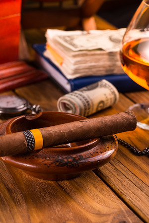 Relaxing cuban cigar after hard day, with glass of Rumの写真素材