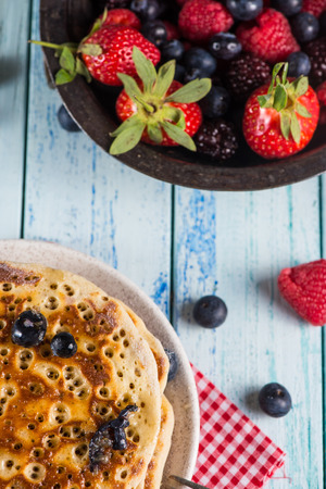 Delicious homemade pancakes breakfast with fresh berries fruits and honeyの写真素材