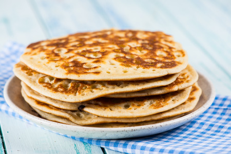 stack of pancakes on rustic wooden table