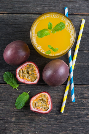 Fresh whle and cut passion fruits and refreshing juice from aboveの写真素材