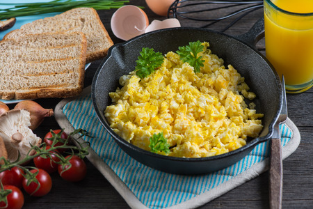 eating healthy breakfast,scrambled egg with wholegrain toast and orange juiceの写真素材