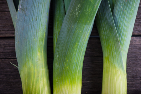 Farm fresh organic leek, spring salad ingredient on wooden tableの写真素材