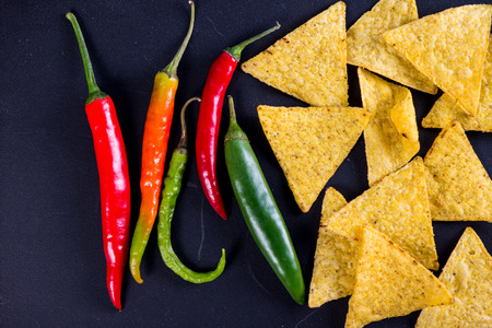 mexican street food nachos with jalapeno on black backgroundの写真素材