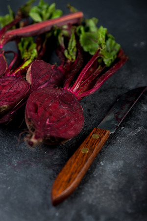 Farm fresh beetroots cut in half on dark backgroundの写真素材