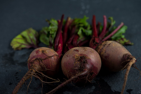 Bunch of whole beetroots farm fresh on dark backgroundの写真素材