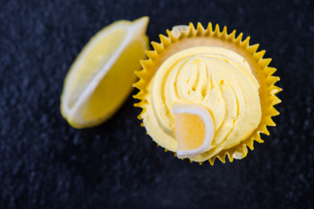 Lemon cupkace decorated with icing on dark backgroundの写真素材