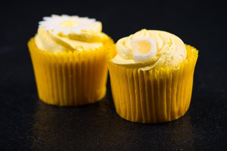 Lemon cupkace decorated with icing on dark backgroundの写真素材
