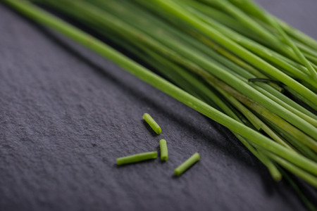 Spring garden fresh chives on black slate  backgroundの写真素材