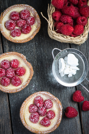 Traditional homemade fresh raspberry tart on wooden tableの写真素材