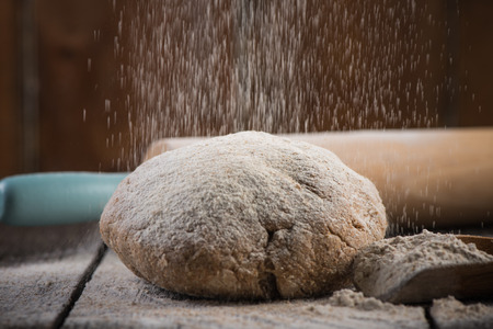 Preparation of wholegrain dough for homemade bread, on wooden rustic tableの写真素材