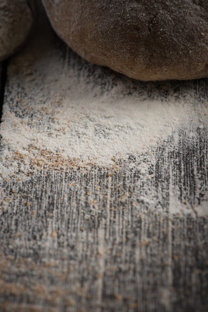 Wholegrain dough for homemade bread, prepared on wooden table, food baking backgroundの写真素材