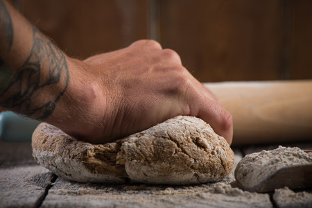 Preparation of wholegrain dough for homemade bread, on wooden rustic tableの写真素材
