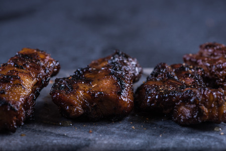 Grilled pork belly slices on marble board and slate background, with copy spaceの写真素材