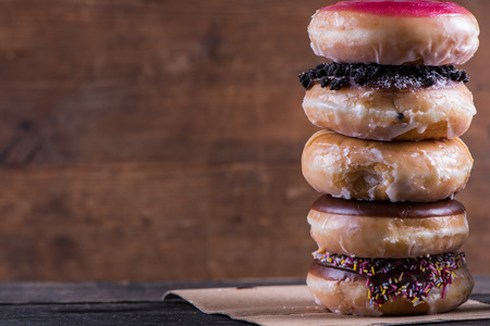 Stack of artisan donuts with wooden rustic background,copy spaceの写真素材