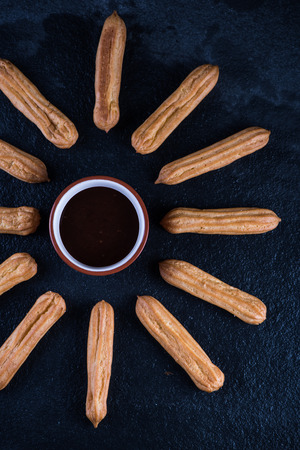 Fried churros with chocolate dip, mexican sun from aboveの写真素材