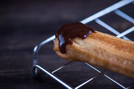 Fresh churros with melting chocolate dip on cooling trayの写真素材