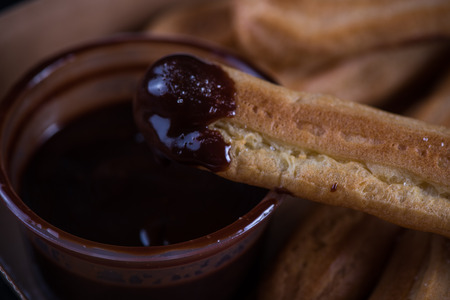 Street food latin churros with chocolate dip, in box
