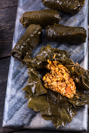 vine leaves stuffed on serving boardの写真素材