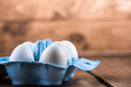 Farm fresh free range eggs on wooden backgroundの写真素材