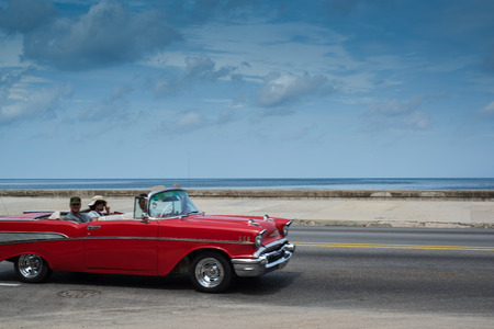 Havana, Cuba - September 28, 2015: Classic american car drive  on Malecon sea front promenade in Havana,Cuba. Classic American cars are typical landmark and tourist attraction for whole Cuban island.のeditorial素材