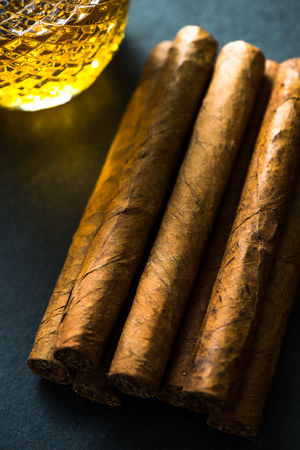 Cigars with alcohol on dark background, from aboveの写真素材