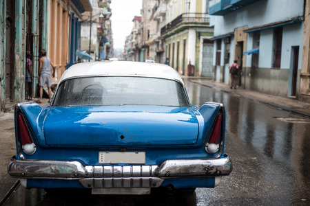 Street scene with old car on rainy day in Havana,Cubaの写真素材