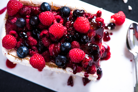 Sweet Pavlova with winter berry fruitsの写真素材