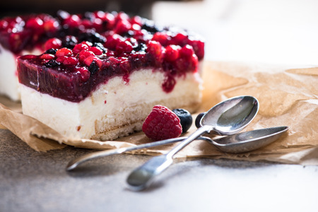 Simple mascarpone cheesecake with winter berry forest fruits, serving slicesの写真素材
