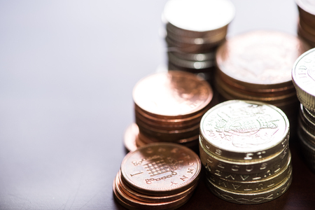 Pile of british pound sterlings coins with blur barckgroundの写真素材