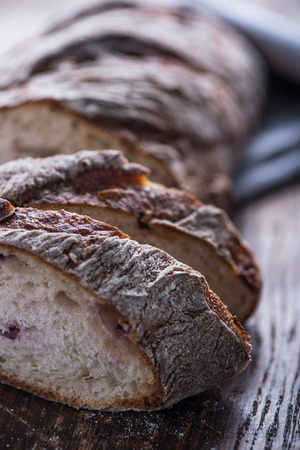 Sharing homemade bread loaf on vintage table