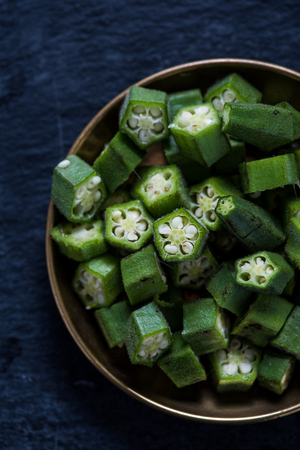 Sliced farm fresh okra in rustic bowlの写真素材