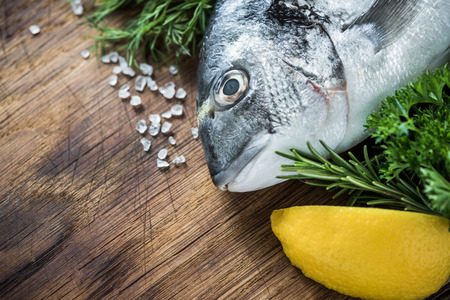 Whole fresh fish with lemon and herbs