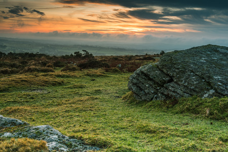 Granite outcrop rock in Dartmoor,UK at dramatic sunsetの写真素材