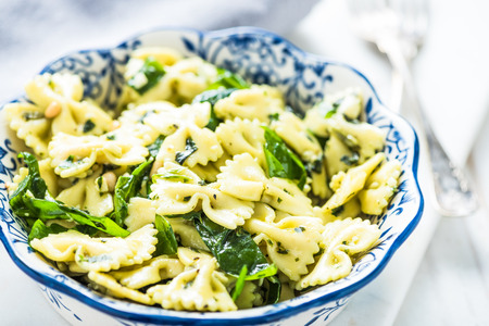 Spinach and pasta healthy salad in bowlの写真素材
