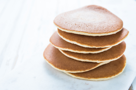 American pancakes pile on white backgroundの写真素材