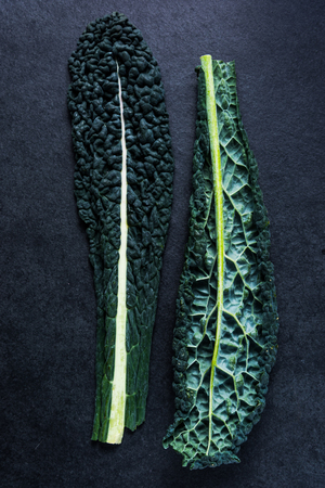 Fresh kale leaves on dark slate background.Lay flat from overhead.の写真素材