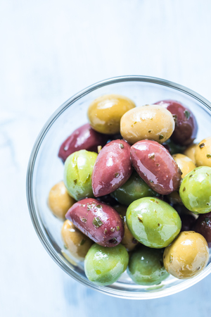 Fresh whole olives in bowl, with oil and spices.Spanish tapas concept.の写真素材
