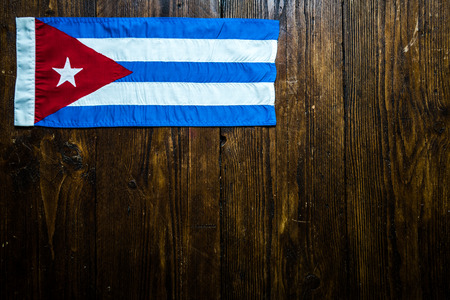 Cuban national flag on wooden table.Lay flat from above.