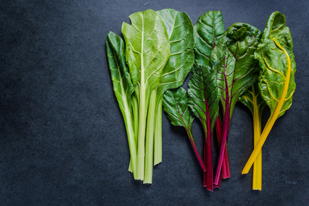 Swiss rainbow chard, vibrant vegetable. Flat lay, from above on dark slate.の写真素材