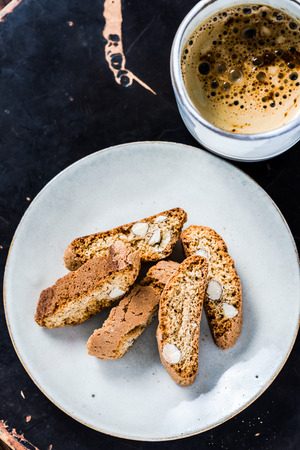 italian cantucci cookies with coffee, on wooden rustic tray from aboveの写真素材