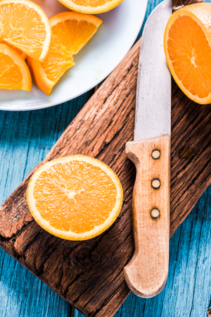 Organic fresh orange slices, vibrant colors on wooden tableの写真素材