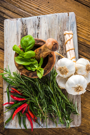Fresh whole garlic and spices on chopping board, overhead view with copy spaceの写真素材