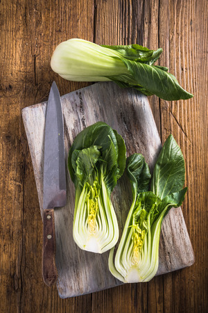 cabbage cut in halves on wooden board, view from aboveの写真素材