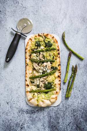 Woodfire baked artisan pizza with asparagus and chickenの写真素材