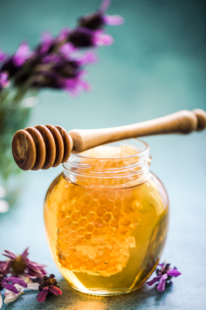 taste of summer, honey with comb and lavender, bright and vibrant sunny colorsの写真素材